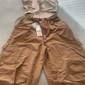 Cargo pants light weight fabric with functional pockets, drawstring waistband.